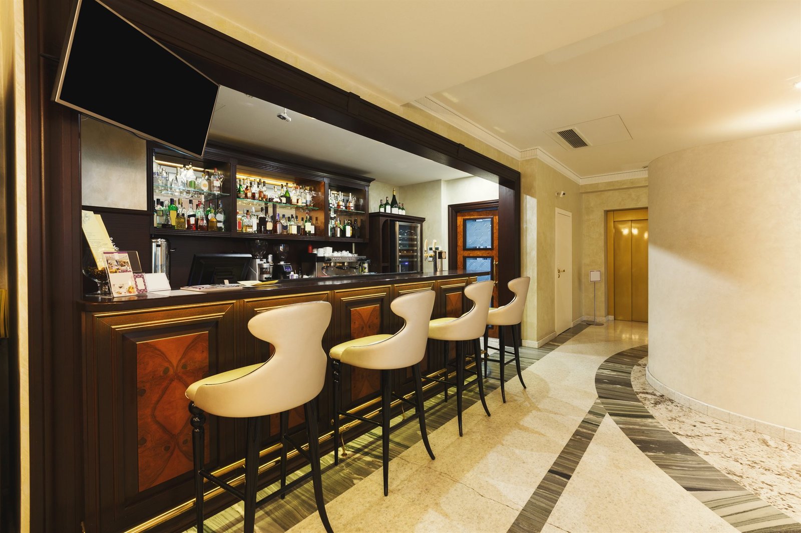 Bespoke luxury hospitality bar lounge with bottle shelves and custom seating